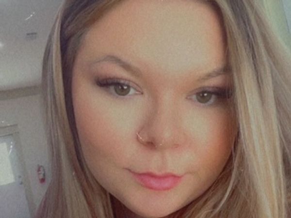 Close-up of a woman with blonde hair and a nose ring.
