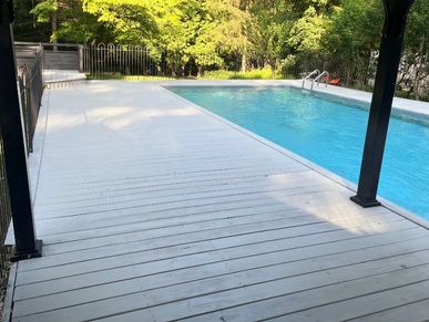 Deck around pool that was pressure washed and stained