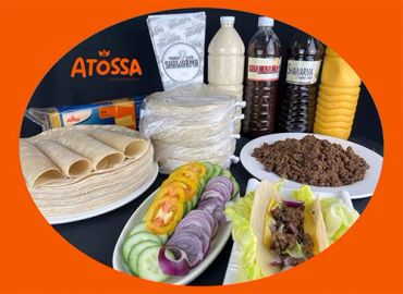 Atossa shawarma ingredients arranged with sauces and fresh vegetables.