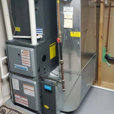 Modern Daikin HVAC system installed in a clean basement.
