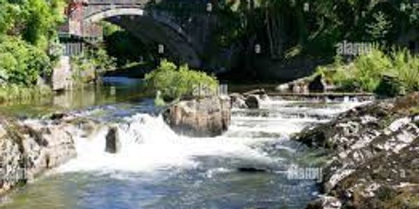 Bridge and waterfalls on River Wye in Rhayader, Powys – scenic stop riverside glamping pods wales