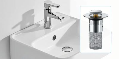 Modern bathroom sink with a chrome faucet and drain strainer.