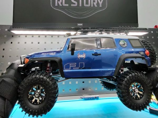 RC Story Operator holding an RGT 1/10 Scale FJ Cruiser RC Crawler