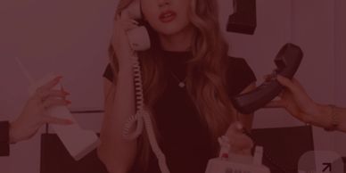 Woman overwhelmed with multiple phones ringing.