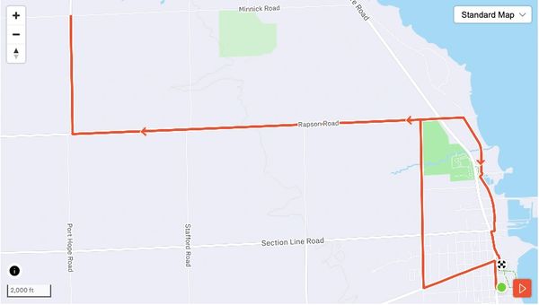 A marked route on a map with roads and a finish flag.