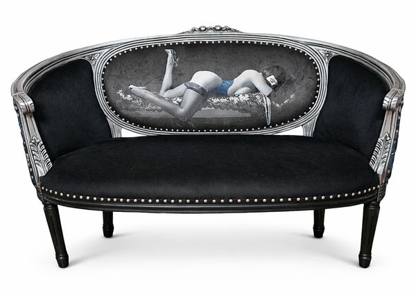 Elegant black sofa with artistic reclining woman design on backrest.