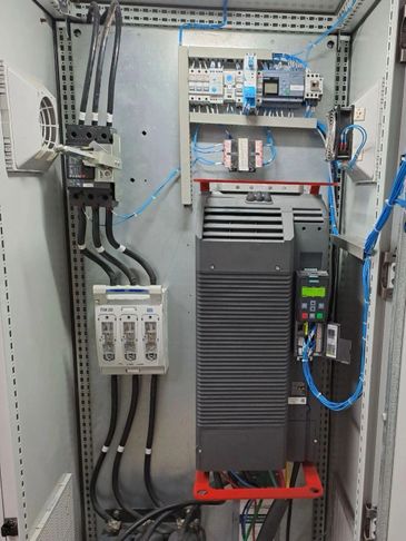 Industrial electrical control panel with wiring and circuit breakers.
