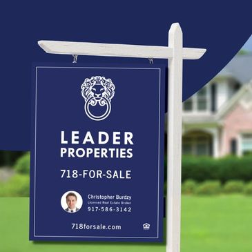 Leader Properties real estate sign hanging on a post