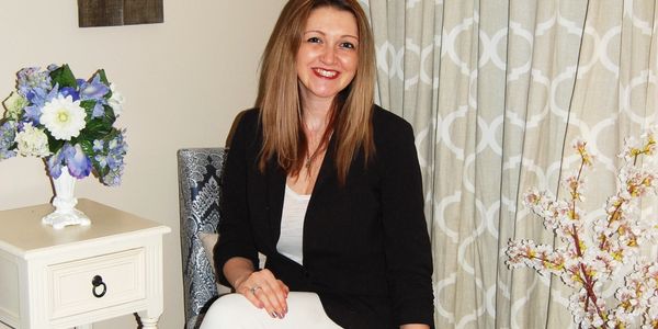 Teelah Hall, MBA. Owner of Visionaries of Vermont with her dog Moose.