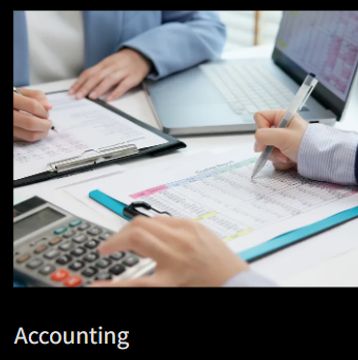 Accountants reviewing financial documents and using a calculator.