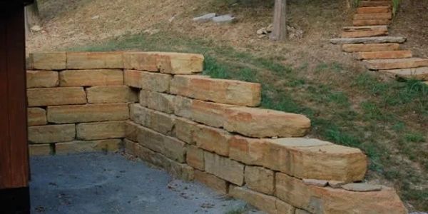 Terraced stone retaining wall on a slope.