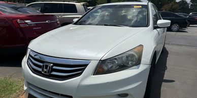 White Honda car parked outdoors.