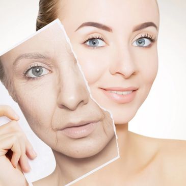 Woman holding a torn photo of an older face over her own youthful face.