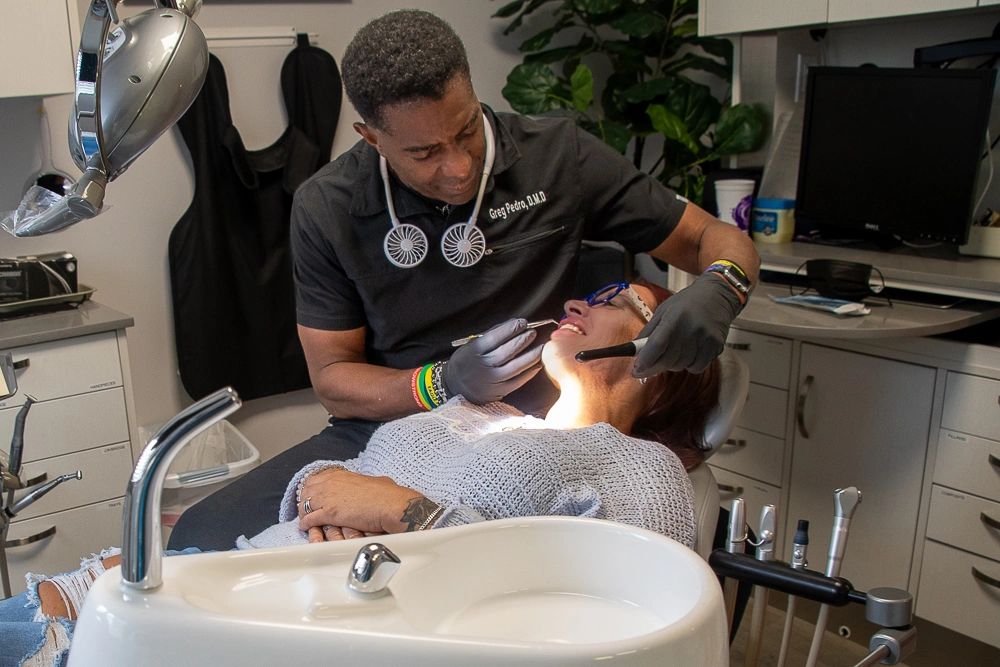 Dentist examining a patient's teeth in a dental clinic.