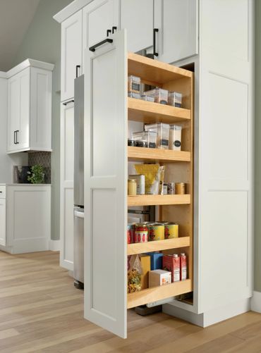 A tall, pull-out pantry shelf fully stocked with various food items in a modern kitchen.