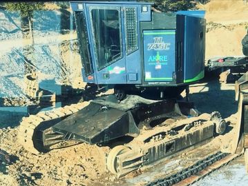 Tracks off of a Timberpro being put back on 