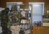 Soldiers in MOPP 4 conduct sensitive site exploitation