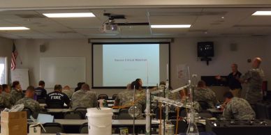 Military personnel attending a classroom presentation.