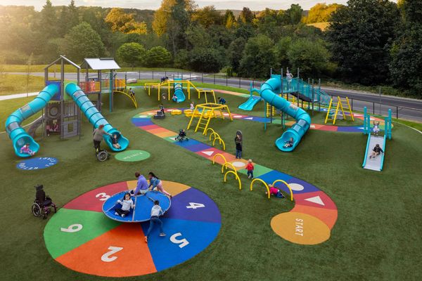 Outdoor playground with children on slides and playing on equipment