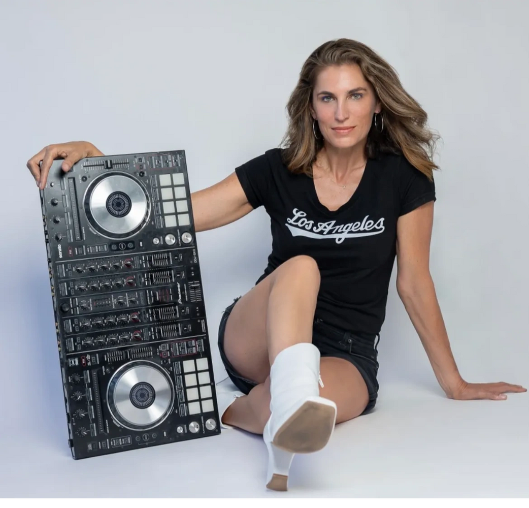 A woman posing with a dj controller