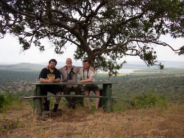 My brother, my dad and me sat on a bench, over looking the Queen Elizabeth National Park