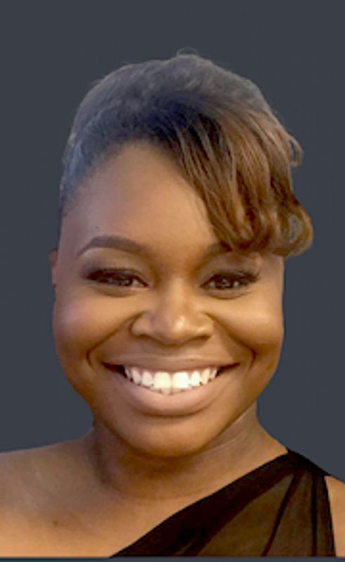 Smiling woman with styled hair and elegant black dress.