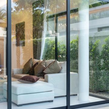 Modern aluminum sliding glass window system with seamless indoor-outdoor transition