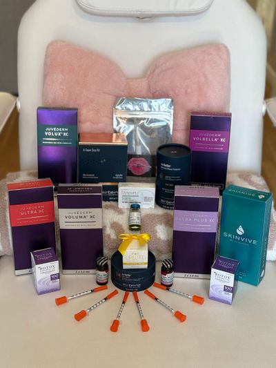 Collection of skincare and cosmetic products with syringes arranged in front.