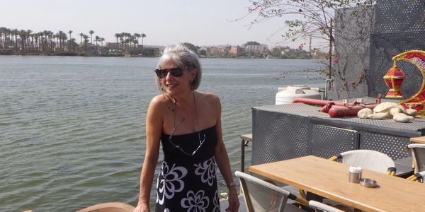 The woman standing and giving pose for picture
