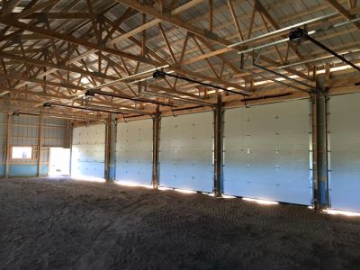 Interior of a large garage with multiple sectional doors.