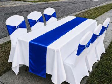 White table setup with blue accents outdoors.