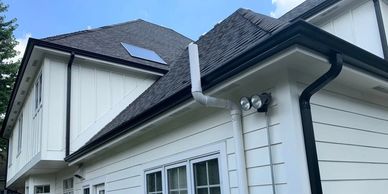picture of siding, roofing, and gutters of a house. 