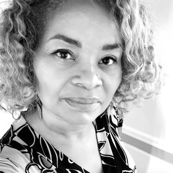 Black and white portrait of a woman with curly hair.