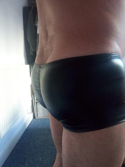 James the sensual masseur's bum with wet-look shorts