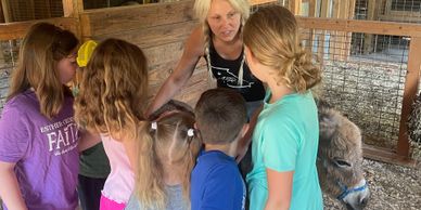 Farmer telling children about donkeys