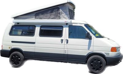 White camper van with extended roof for camping purposes.