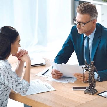 A lawyer consulting with a client in an office setting.