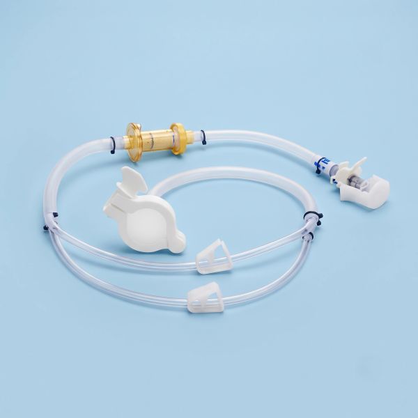 Medical catheter tubing with connectors on a blue background.