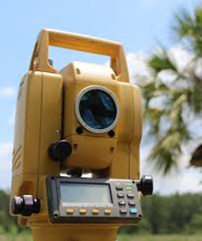 Yellow surveying instrument outdoors.