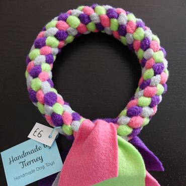 Ring toy in purple, cerise pink, lime green and grey.
