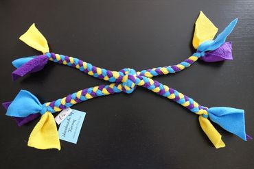 Small plaited toy with 4 ends, yellow, turquoise and purple.
