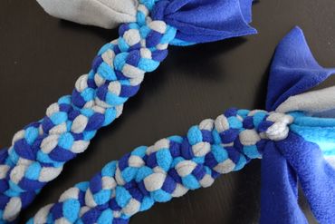 3 small plaits plaited together. Each plait made from 3 different colours. 2 blues and grey.