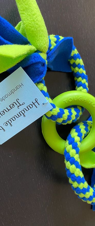 2 small handmade rings in lime green and royal blue interlocked with a lime green rubber ring.