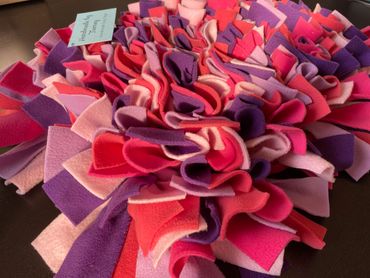 Brightly coloured Snuffle mat in cerise pink, purple, pale pink, lilac and coral.