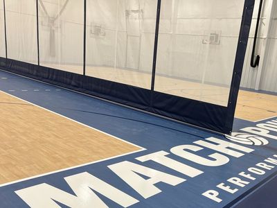 Indoor basketball court with MATCHPOINT Performance Center logo.