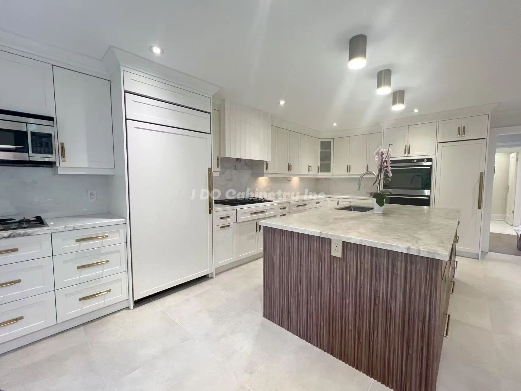 Modern kitchen with white cabinetry and a wood-accented island.