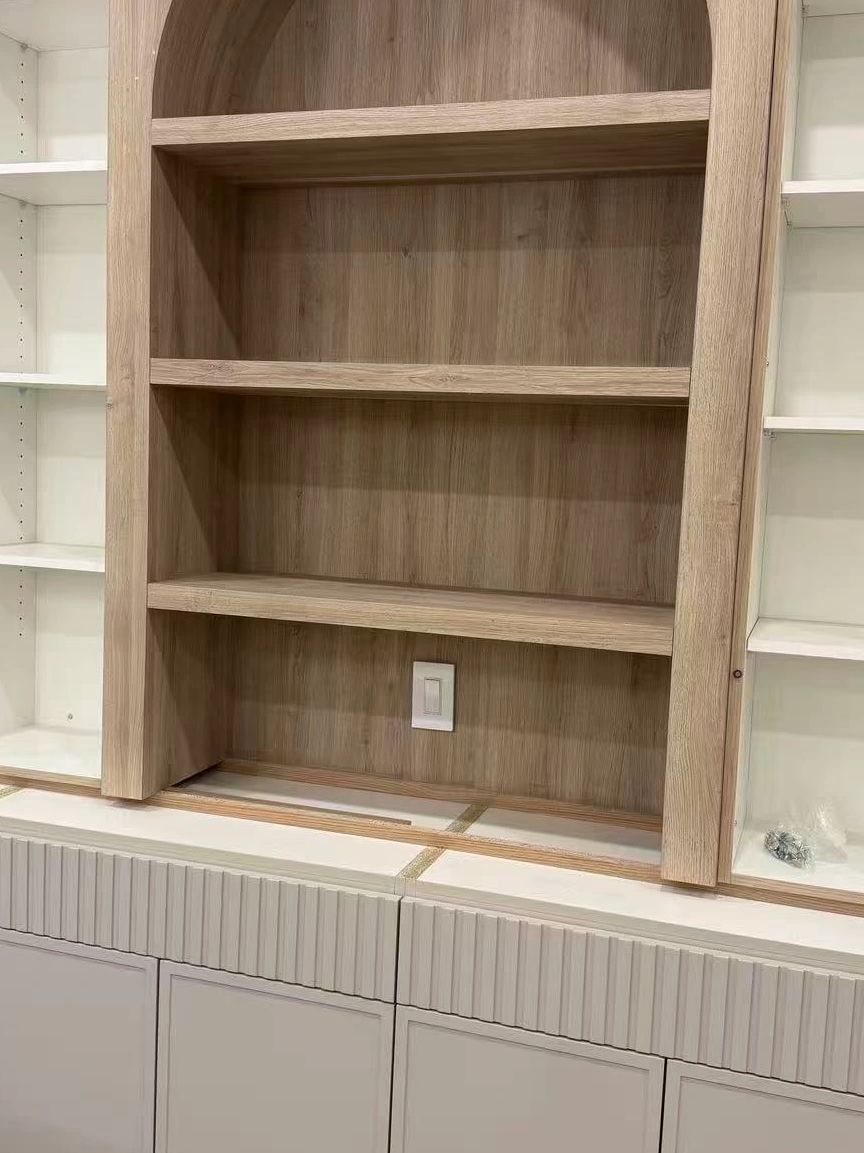 Wooden and white shelving unit with a light switch in the center.