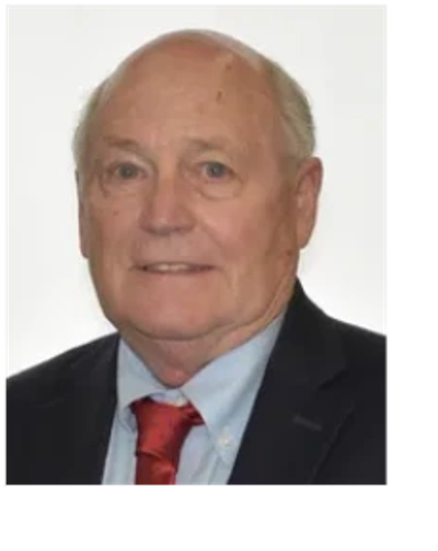 Portrait of an elderly man in a suit and red tie.