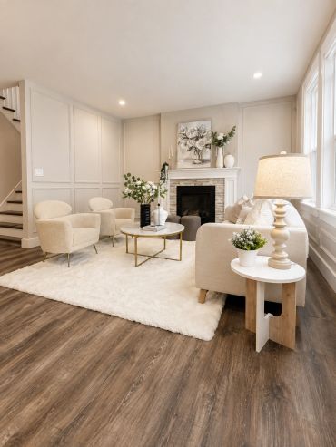 Bright living room with beige furniture and wooden floor.