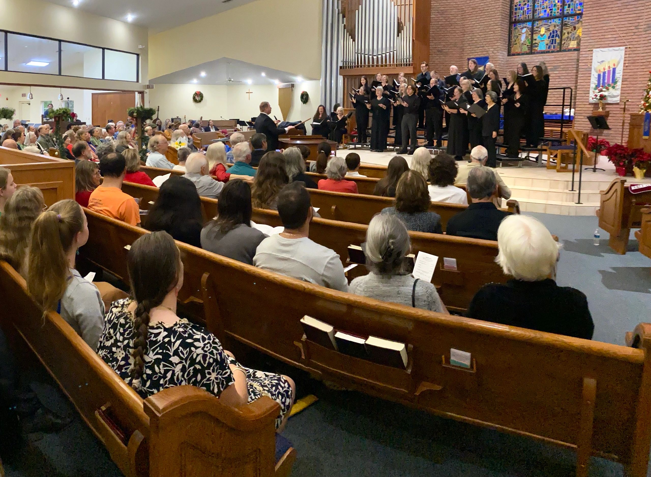 View of Capella Nova in concert from the back of the sanctuary showing a full house.